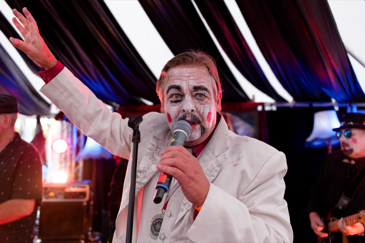 Face-painted performer at a community festival