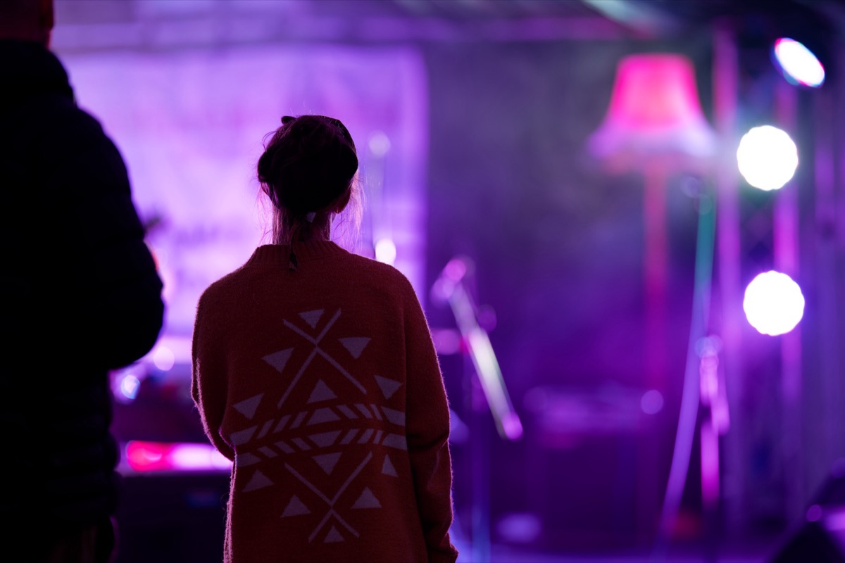 Musician silhouetted in purple stage lighting