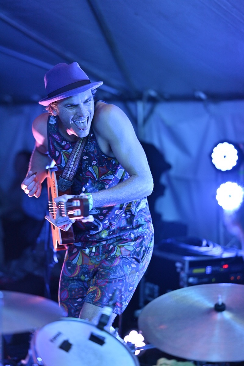 Guitarist performing in blue stage lighting