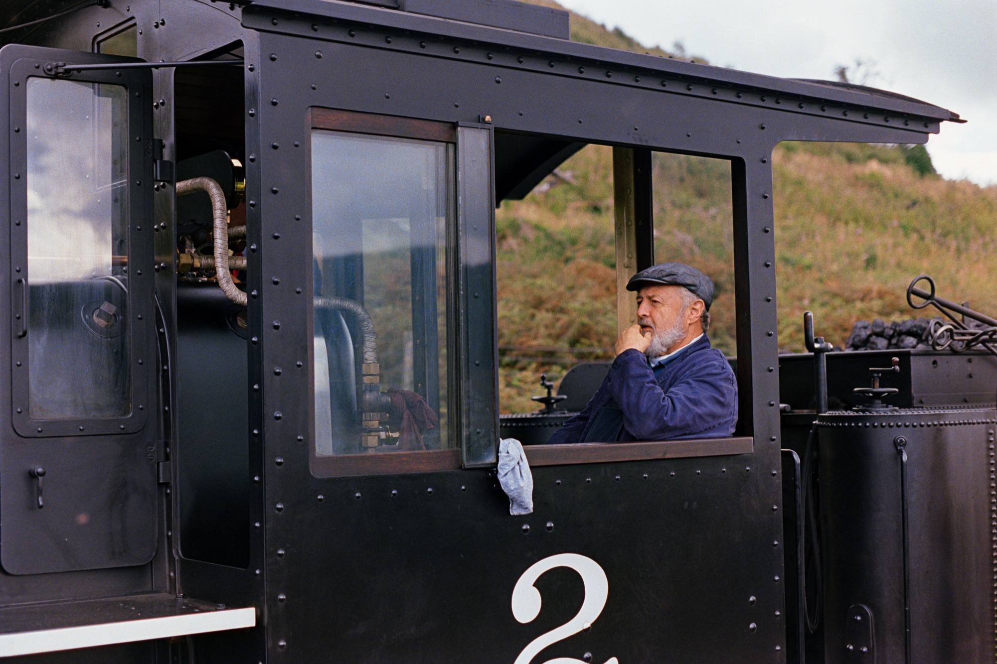 Steam train driver in locomotive cab