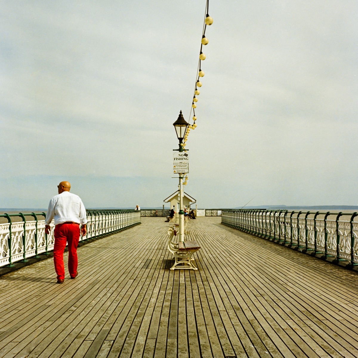 Penarth Pier with vintage lamppost and beach huts